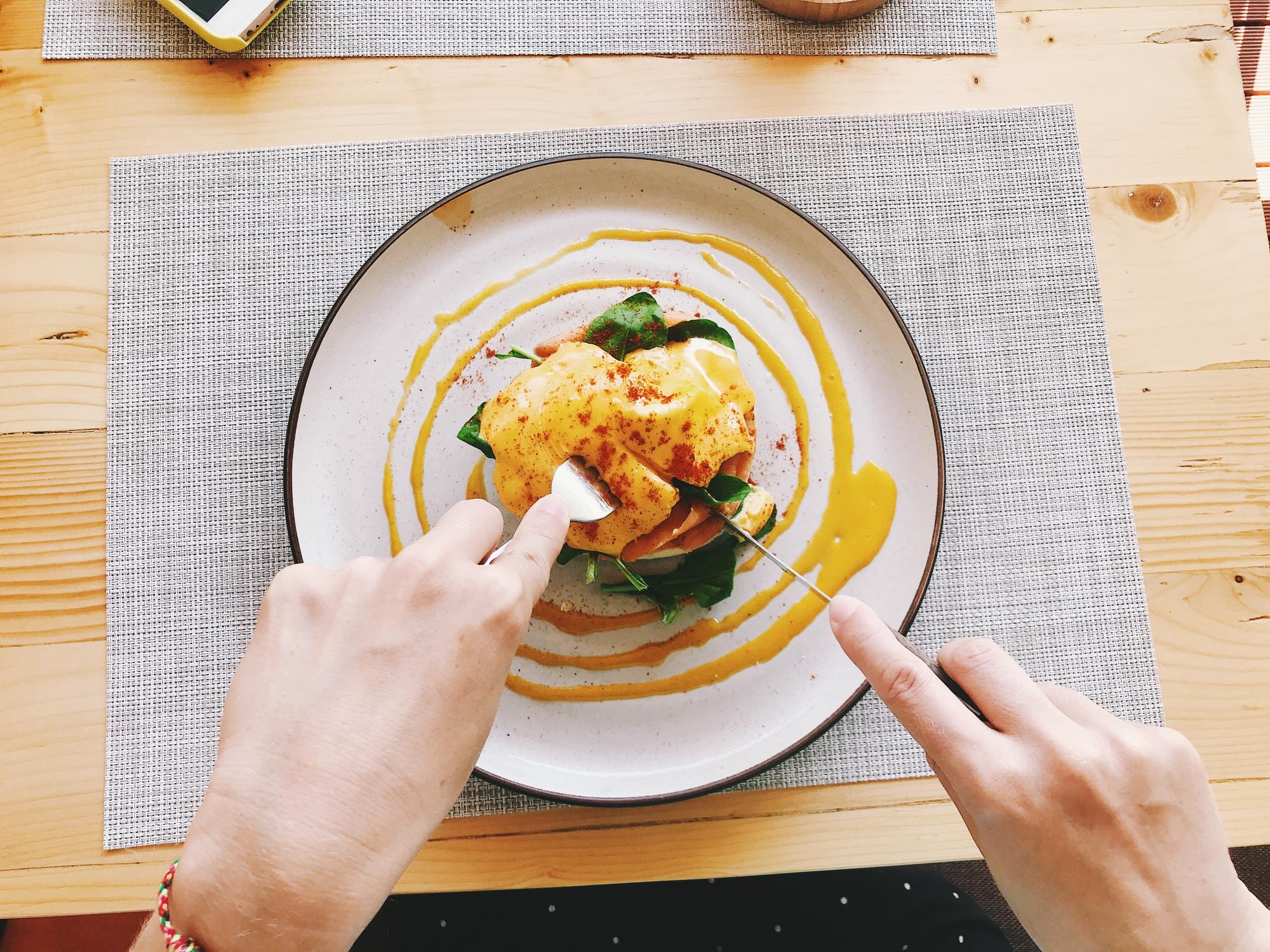 Close-up of hands plating a simple dish